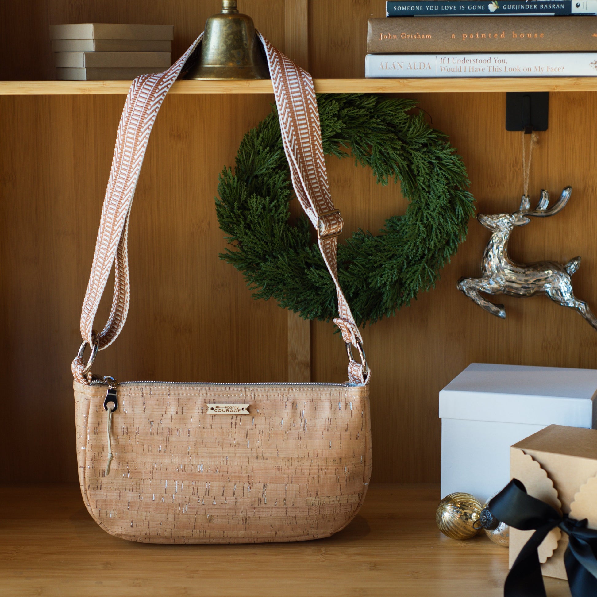Beige handbag on a wooden shelf with decorative items
